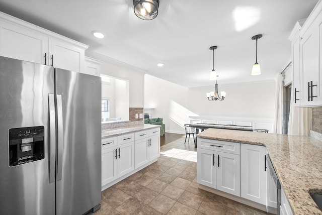 kitchen with white cabinets, pendant lighting, and stainless steel appliances