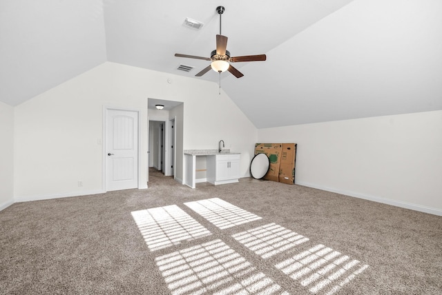 bonus room featuring light colored carpet, vaulted ceiling, ceiling fan, and sink