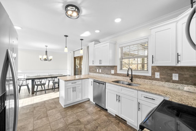 kitchen with white cabinetry, sink, stainless steel appliances, kitchen peninsula, and pendant lighting