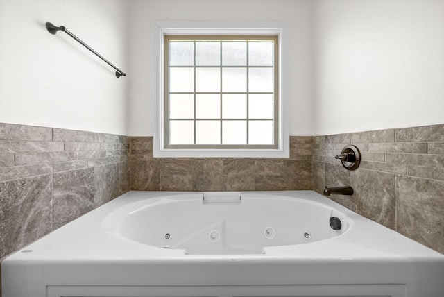 bathroom with a tub to relax in