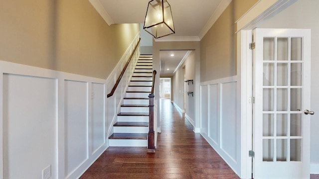 entryway with crown molding and dark hardwood / wood-style flooring