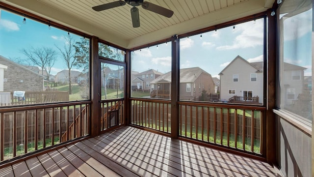 unfurnished sunroom featuring ceiling fan