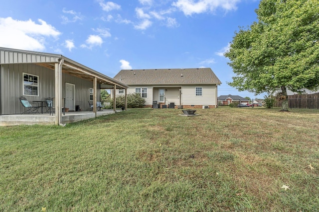 back of property featuring a yard and a patio area