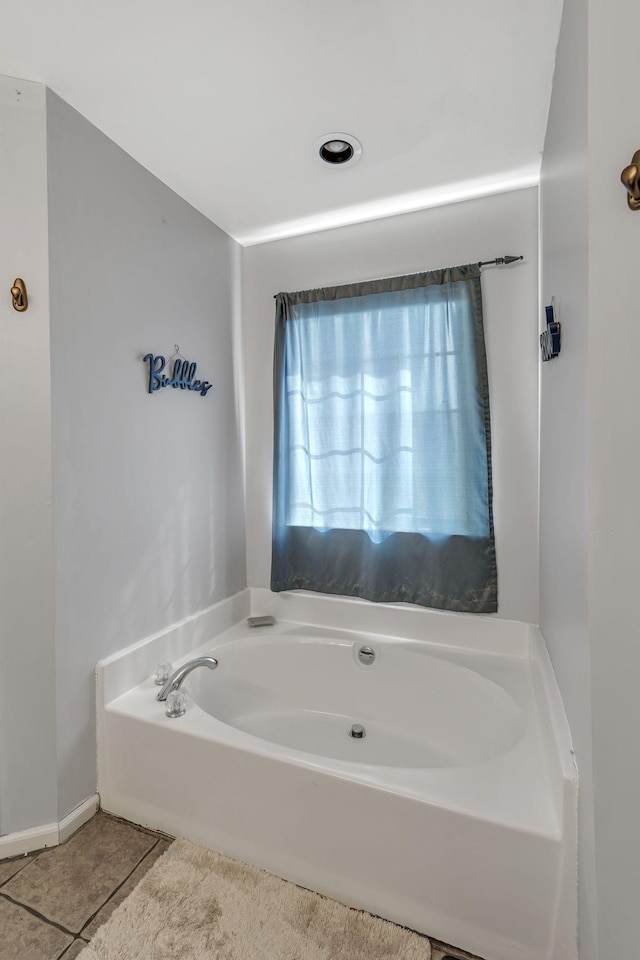 bathroom with a tub to relax in