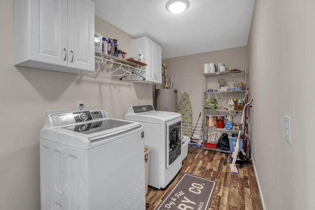 washroom featuring separate washer and dryer, gas water heater, cabinets, and dark hardwood / wood-style floors