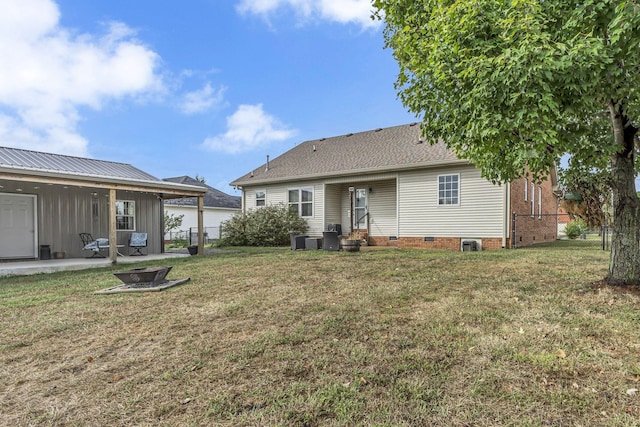 rear view of property with central air condition unit, a yard, and a patio