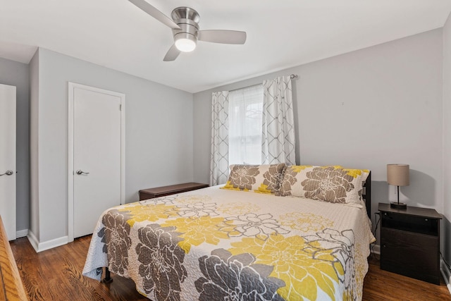 bedroom with ceiling fan and dark hardwood / wood-style floors