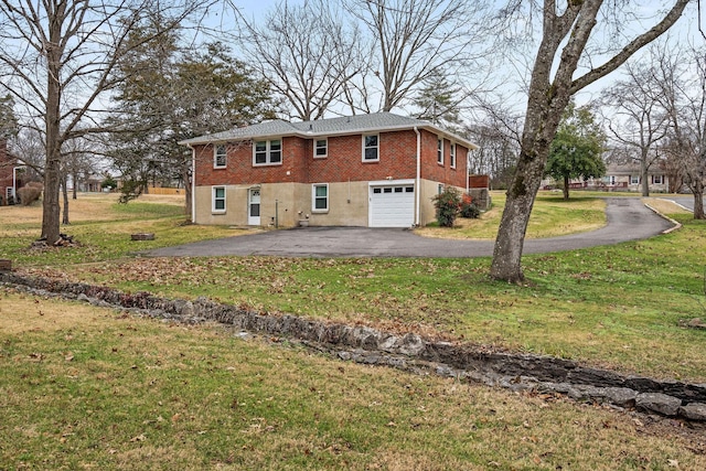 exterior space with a garage and a yard