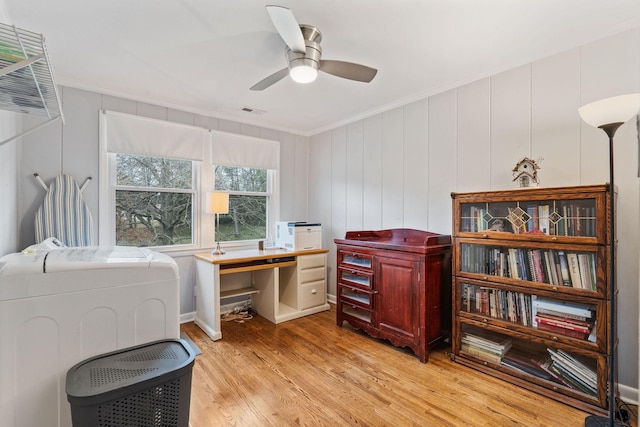 office area featuring ceiling fan, washing machine and dryer, crown molding, and light hardwood / wood-style flooring