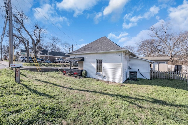 view of home's exterior with a yard and central air condition unit