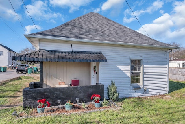 back of property featuring a yard