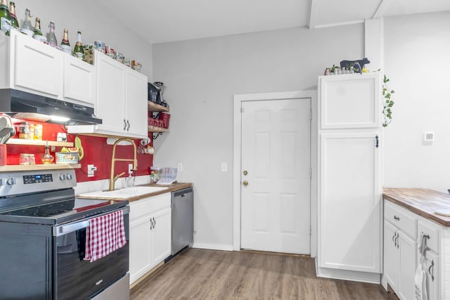 kitchen with white cabinetry, sink, stainless steel appliances, wood counters, and wood-type flooring