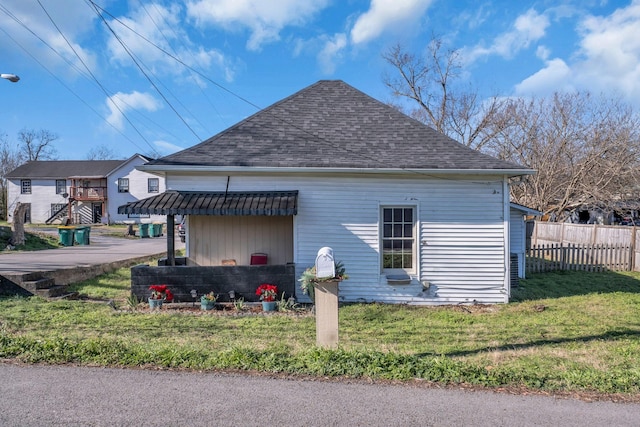 rear view of house with a yard