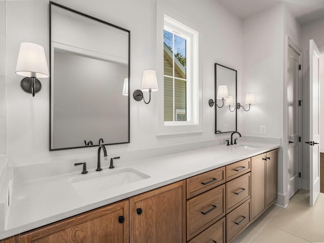 bathroom with tile patterned flooring, vanity, and a healthy amount of sunlight