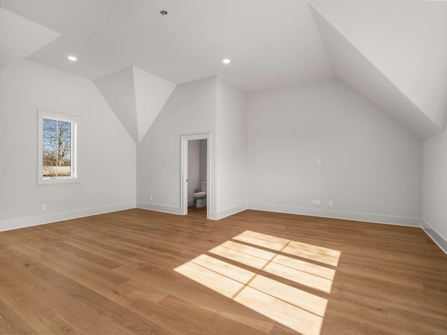 bonus room featuring lofted ceiling and hardwood / wood-style flooring