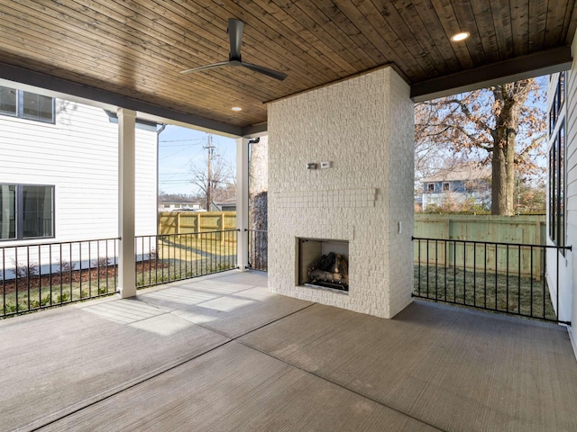 view of patio / terrace with an outdoor brick fireplace and ceiling fan