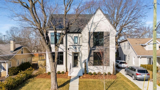 english style home with a front yard