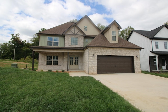 view of front of property with a front lawn, covered porch, and a garage