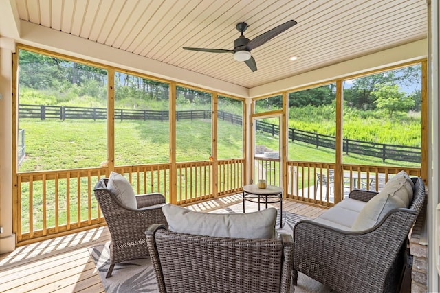 sunroom / solarium featuring ceiling fan