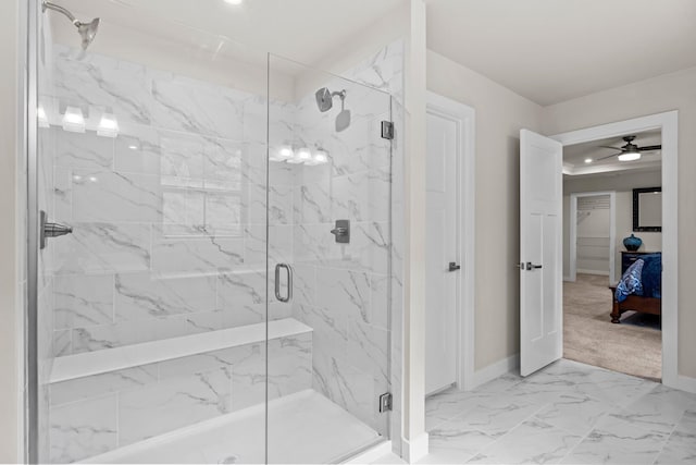 bathroom featuring ceiling fan and a shower with shower door