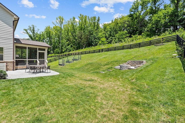 view of yard featuring a sunroom and a patio