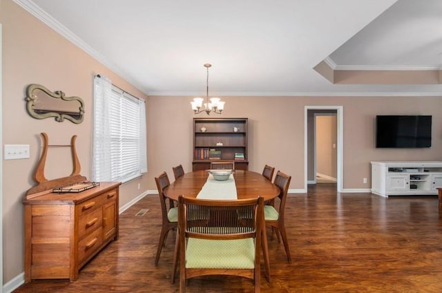 dining room with dark hardwood / wood-style floors, crown molding, and a chandelier