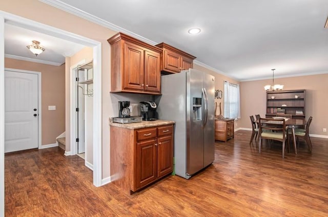 kitchen featuring stainless steel fridge, dark wood-type flooring, a chandelier, and ornamental molding