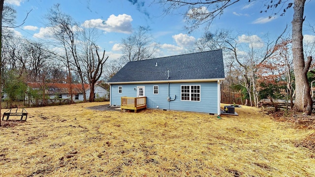 back of property with central air condition unit and a lawn