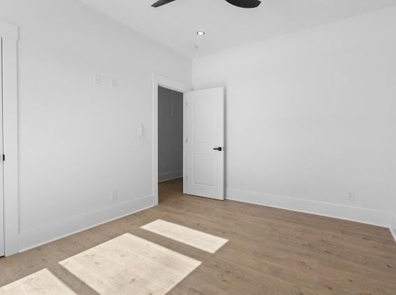 spare room with ceiling fan, recessed lighting, light wood-style flooring, and baseboards