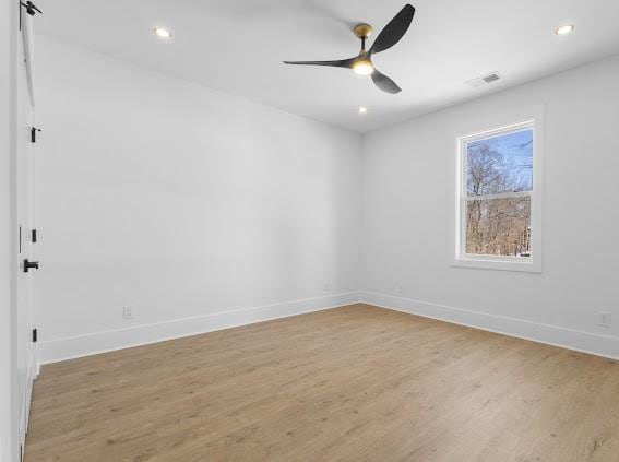 spare room featuring baseboards, visible vents, ceiling fan, light wood-type flooring, and recessed lighting