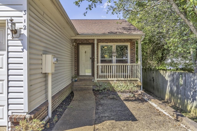 view of exterior entry with covered porch