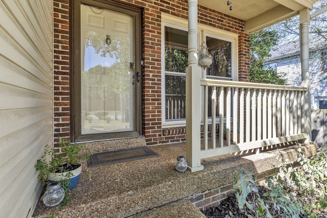 view of exterior entry featuring a porch