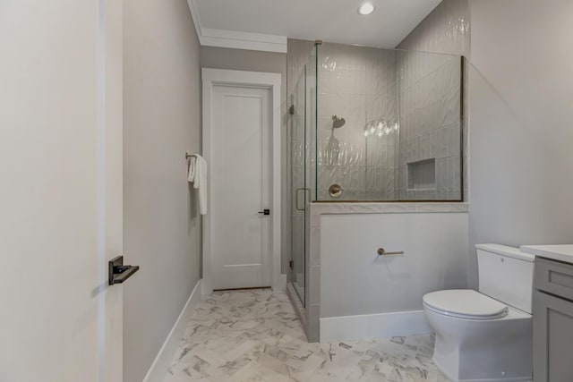 bathroom featuring toilet, crown molding, a shower with door, and vanity