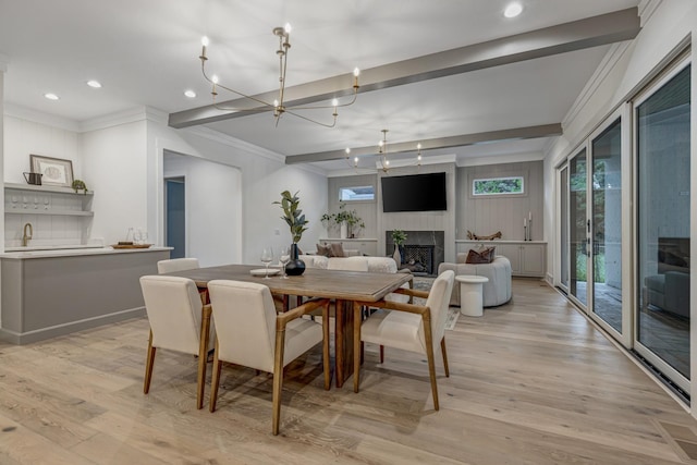 dining space with light hardwood / wood-style floors and a chandelier