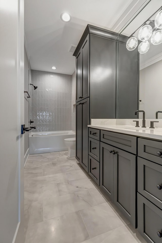 full bathroom with toilet, tiled shower / bath combo, and vanity