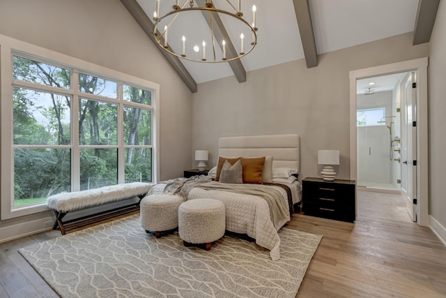 bedroom featuring multiple windows, beamed ceiling, and light wood-type flooring