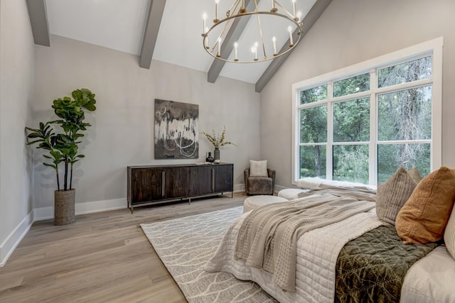 bedroom featuring vaulted ceiling with beams, light wood-type flooring, and a notable chandelier