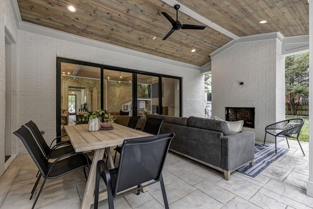 view of patio / terrace featuring ceiling fan and an outdoor living space with a fireplace