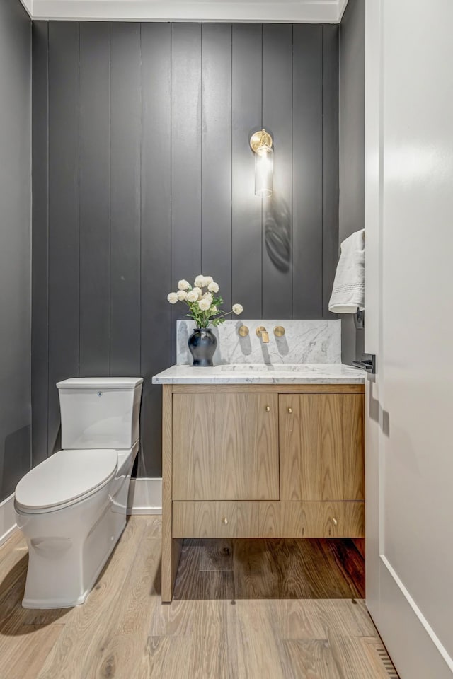 bathroom featuring hardwood / wood-style floors, toilet, and vanity