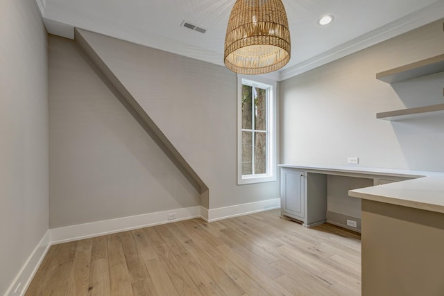 unfurnished dining area with crown molding and light hardwood / wood-style floors