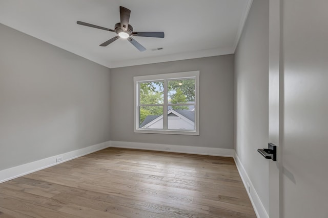 empty room featuring ceiling fan, crown molding, and light hardwood / wood-style floors