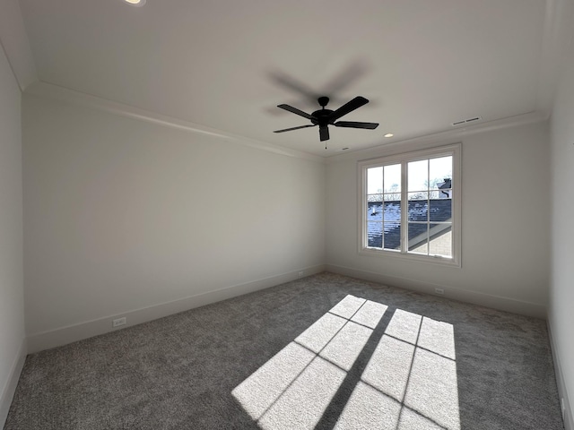 unfurnished room featuring ceiling fan, ornamental molding, and dark colored carpet