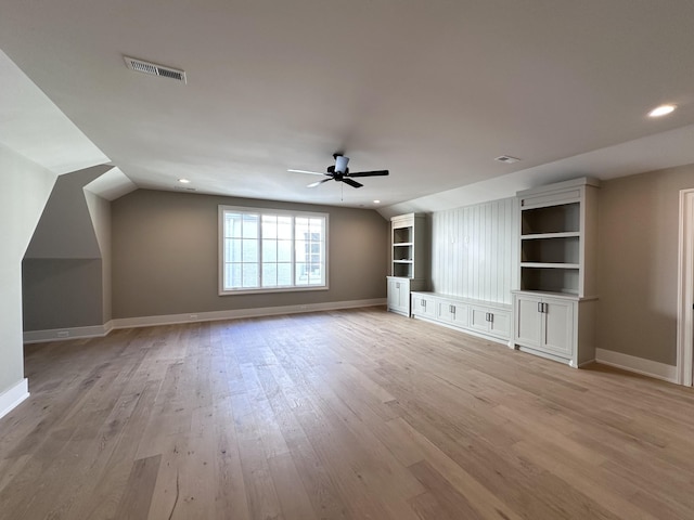 unfurnished living room with lofted ceiling, light wood-type flooring, and ceiling fan