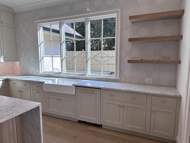 kitchen featuring white cabinetry, decorative backsplash, and light hardwood / wood-style floors