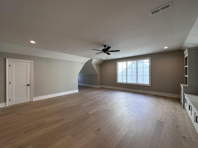 additional living space with ceiling fan, lofted ceiling, and light hardwood / wood-style floors