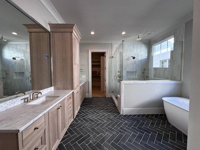 bathroom featuring plus walk in shower and vanity