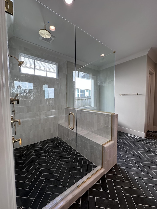 bathroom with walk in shower and crown molding