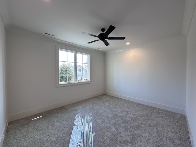 unfurnished room featuring ceiling fan, carpet, and crown molding