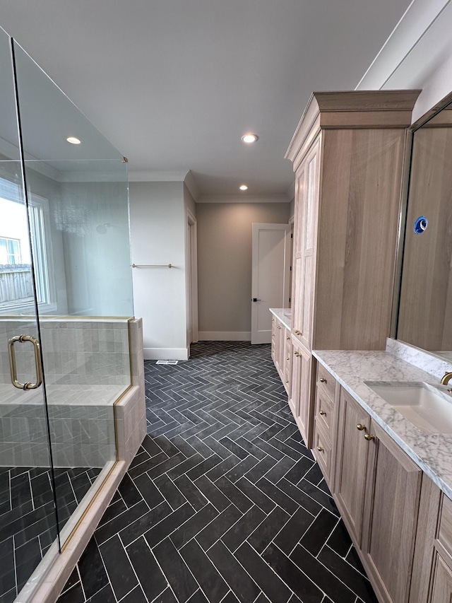 bathroom with vanity, crown molding, and an enclosed shower