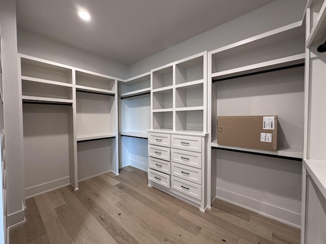 walk in closet with light wood-type flooring